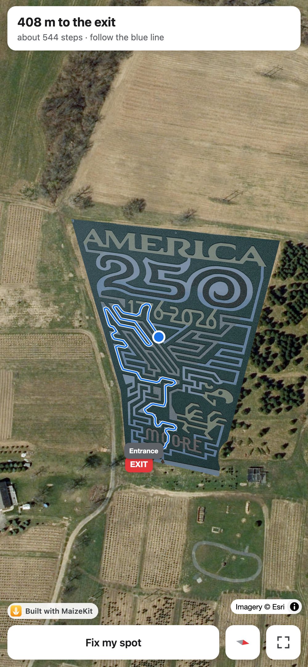 MaizeKit on an iPhone: a corn maze on satellite imagery, a blue dot and a blue route to the exit, 408 m away